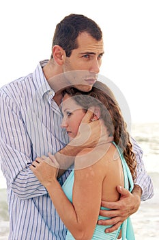 Man holding woman close comforting her