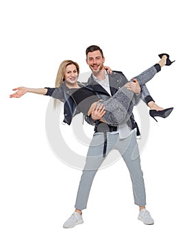 A man is holding a woman in his arms