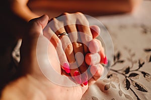 Man holding woman`s hand with engagement ring on the finger