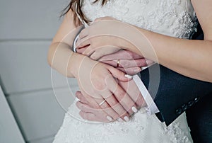 Man holding woman& x27;s hand with engagement ring, wedding day