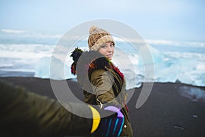 Man Holding Woman`s Hand at Iceland Beach