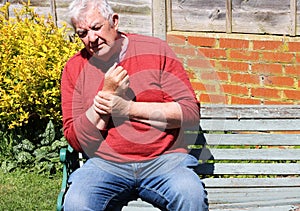 Man holding wrist. painful arthritis.