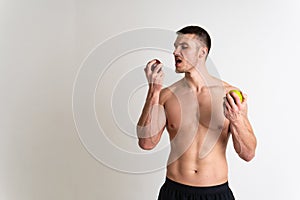 Man holds apples in fitness white background isolated healthy man fitness, sexy food lifestyle background, bodybuilding