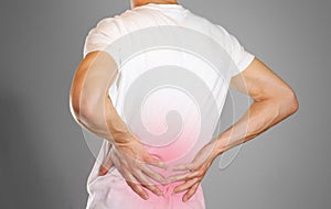 A man holds back. Pain in the lower back. Andros. Sore point