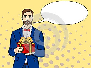 Man holds big gift box. Raster in retro comic pop art style. A guy with christmas or birthday gift. text bubble