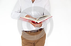 A man holds a big red book in his hands.