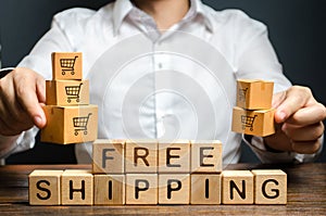 A man holds boxes over the inscription free shipping. Promotions preferential terms for large customers and product groups