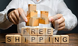 A man holds boxes over the inscription free shipping. Transportation of goods and services, distribution and delivery of orders