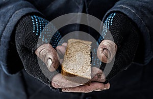 The man holds a bread.
