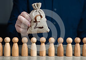 A man holds a british pound sterling money bag above the crowd. Deposits and loans. Budgetary funds for social policy. Salaries.