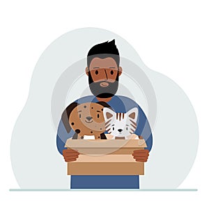 A man holds a cardboard box with a cat and a dog. The concept of rescue, help and care for pets.