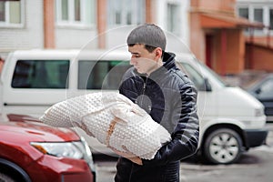 A man holds a child wrapped in a blanket. Father holding his son in his arms