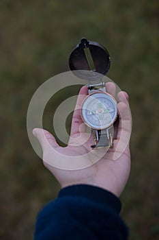 Man holds a compass in his hand. man wathing compass holding in his hands