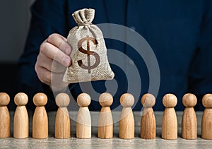 A man holds a dollar money bag above the crowd.