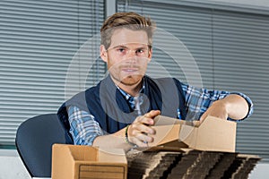 Man holds envelopes in office