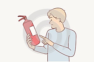 Man holds fire extinguisher checking expiration date equipment for extinguishing flame in emergency