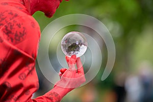 Man holds glass sphere and tells fortune