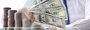 Man holds in his hand fan dollars, investment