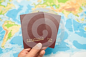 Man holds with his hand the Passport, world map. Travel concept