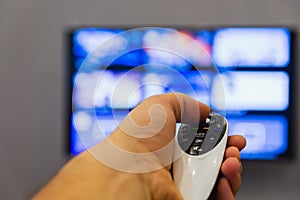 A man holds in his hand TV remote control.