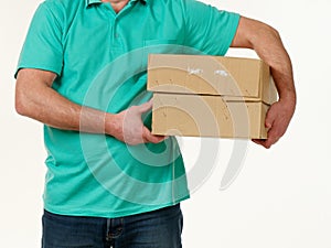 Man holds in his hands a big box on a white background