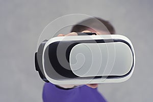 Man holds in his hands glasses for virtual reality and 360-degree video. VR helmet for the smartphone on a light background