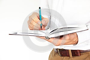 A man holds in his hands a notebook, notebook, diary and pen.