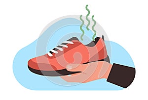 Man holds his shoes in his hand with very bad and unpleasant odor. Smelly shoe, dirt sneakers, mens old boots. Cleaning