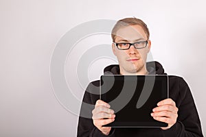 A man holds his tablet computer in the camera