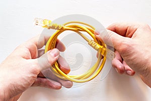 Man holds internet cable in his hands
