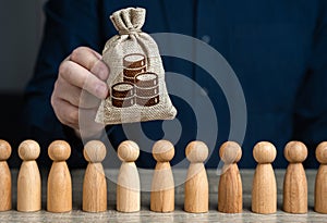 A man holds money bag of coins above the crowd.