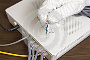 A man holds a network cable in his hand, a close-up, modem and connection