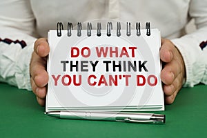 A man holds a notepad in his hands with the inscription - Do what they think you cant do