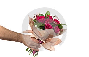 a man holds out a bouquet of flowers. holidays birthdays and weddings. isolated on white