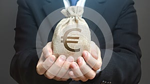 A man holds out a euro money bag. Granting financing business project or education. Provision cash financial loan credit.