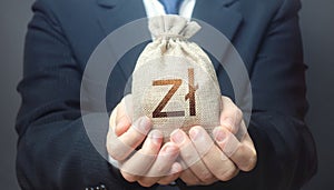 Man holds out a polish zloty money bag. Budget management, collect taxes. Insurance payout. Financial crisis support, benefits photo