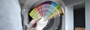 Man holds palette in choosing color for repair