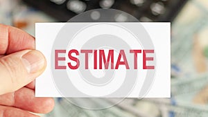 A man holds a piece of paper with the text: estimate. Business and finance concept