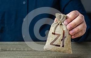 A man holds polish zloty money bag. Deposits and savings.