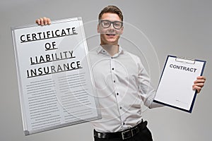 Man holds a poster with inscription certificate of liability insurance and an empty certificate isolated