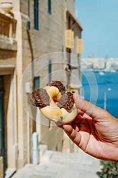 Man holds a qaghaq tal-ghasel in Malta