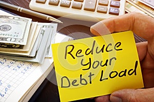 Man holds Reduce your debt load sign