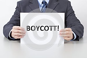 Man Holds a Sheet with a Text Boycott photo