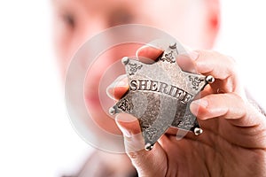 Man holds sheriff badge