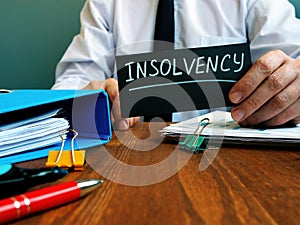 Man holds sign insolvency about  bankruptcy