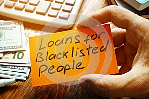 Man holds sign Loans for Blacklisted People