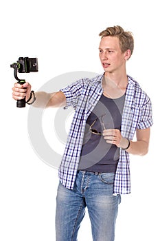 Man holds small action camera.