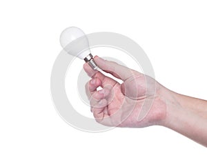 Man holds a small light bulb in his hand with E10 base on a white background, isolate. Close-up, electric power