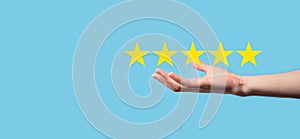 Man holds smart phone in hands and gives positive rating, icon five star symbol to increase rating of company concept on blue