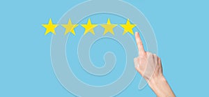 Man holds smart phone in hands and gives positive rating, icon five star symbol to increase rating of company concept on blue